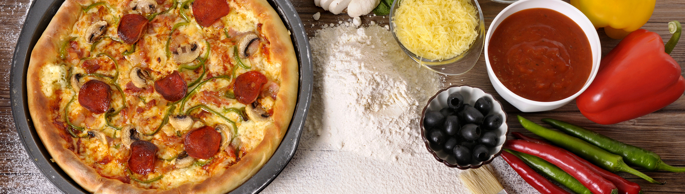 the-word-pizza-written-in-flour-with-various-ingredients-proceli